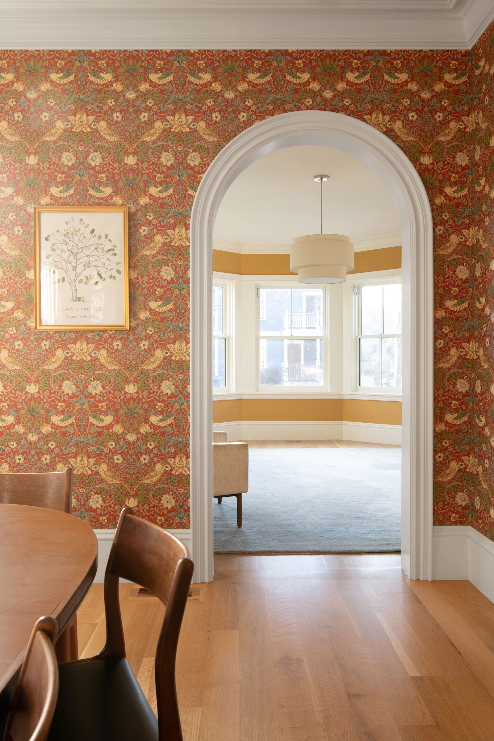 Marvin Double-Hung Bay windows in heritage home, viewed through traditional arch doorway.
