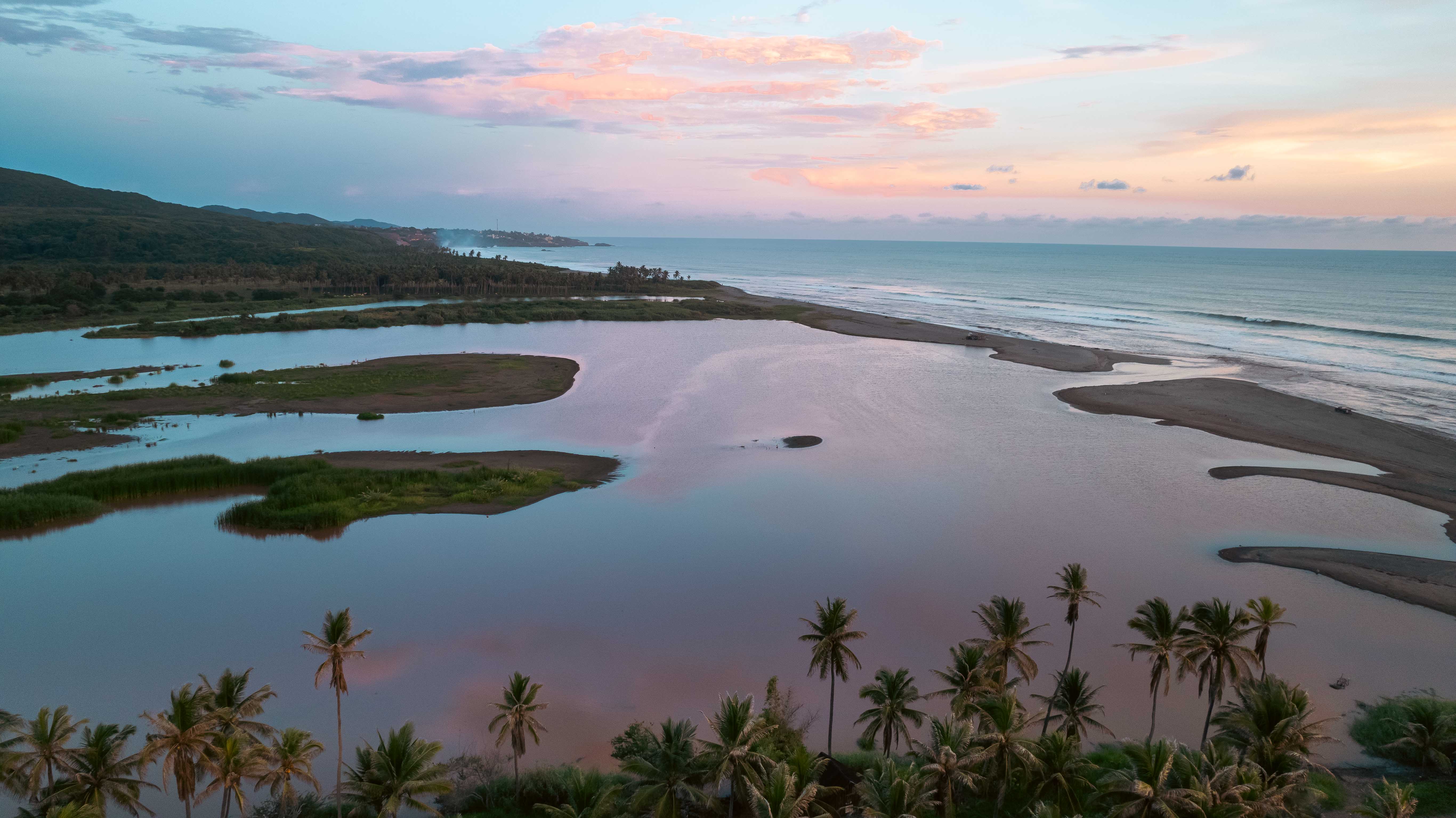 Río Nexpa river and Pacific Ocean at sunset with islands and vibrant reflections in Michoacán, Mexico
