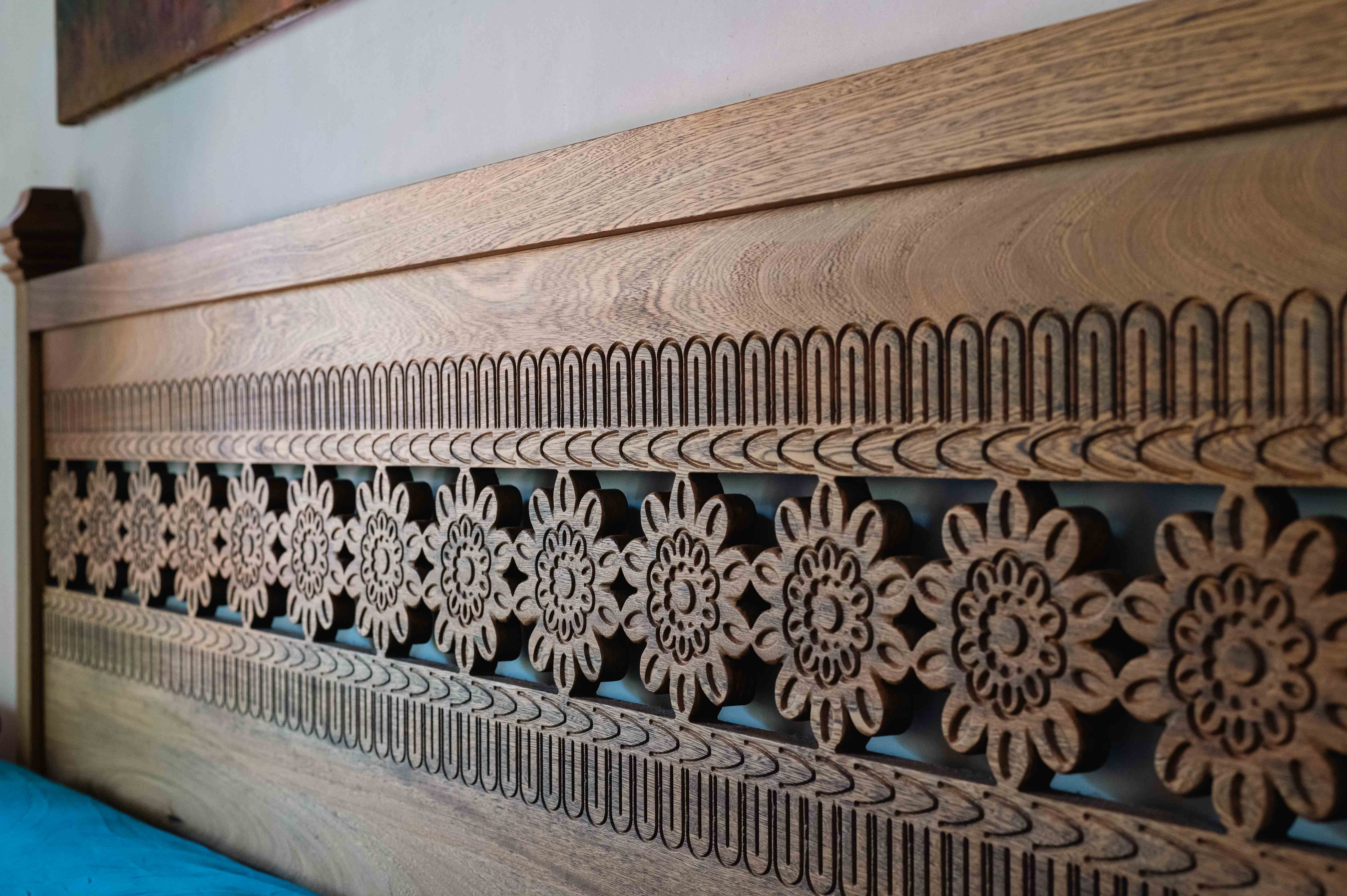 Detailed handcrafted headboard with mandala design in a luxury bedroom