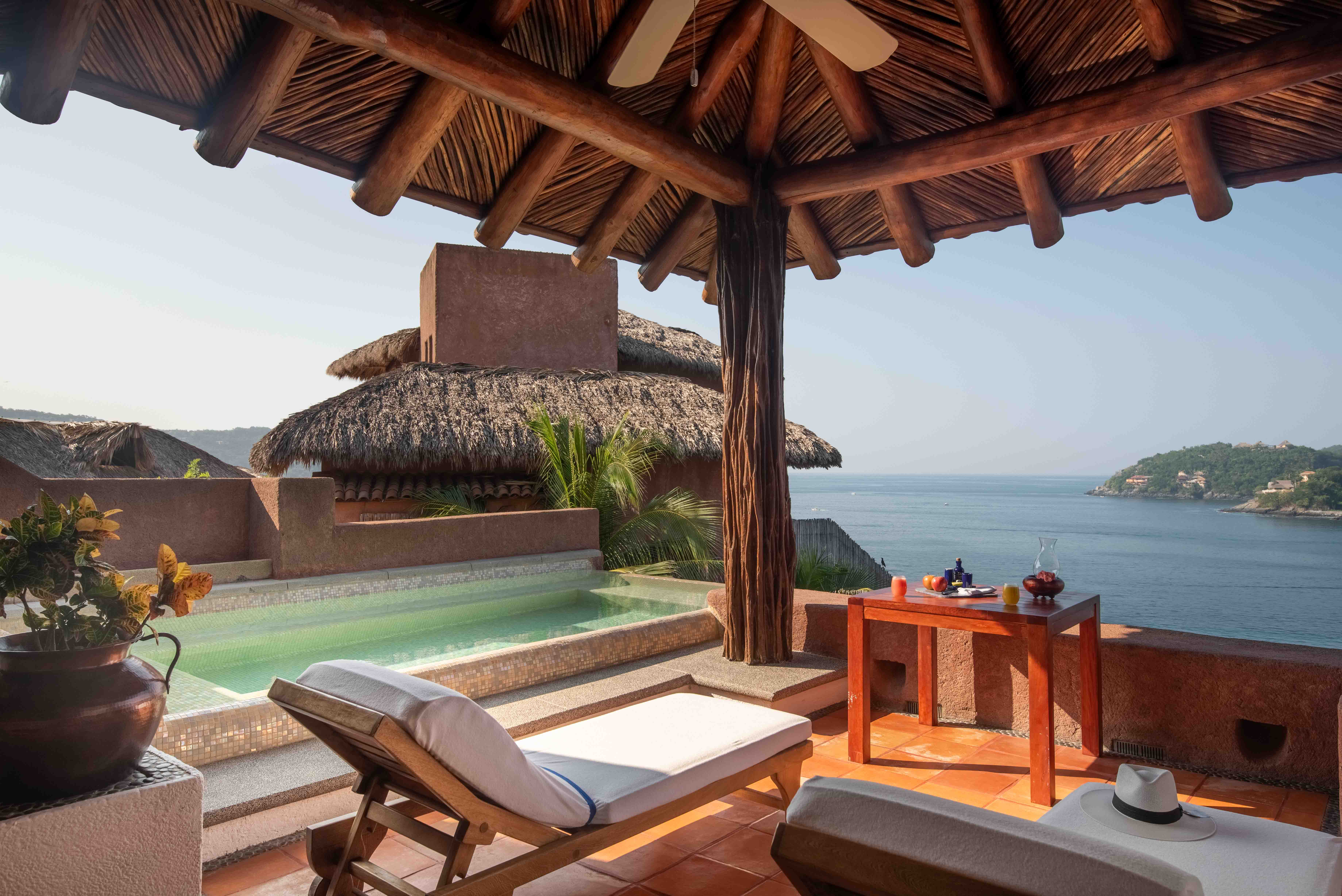 Ocean view terrace at La Casa Que Canta with lounge chair and breakfast overlooking the Pacific