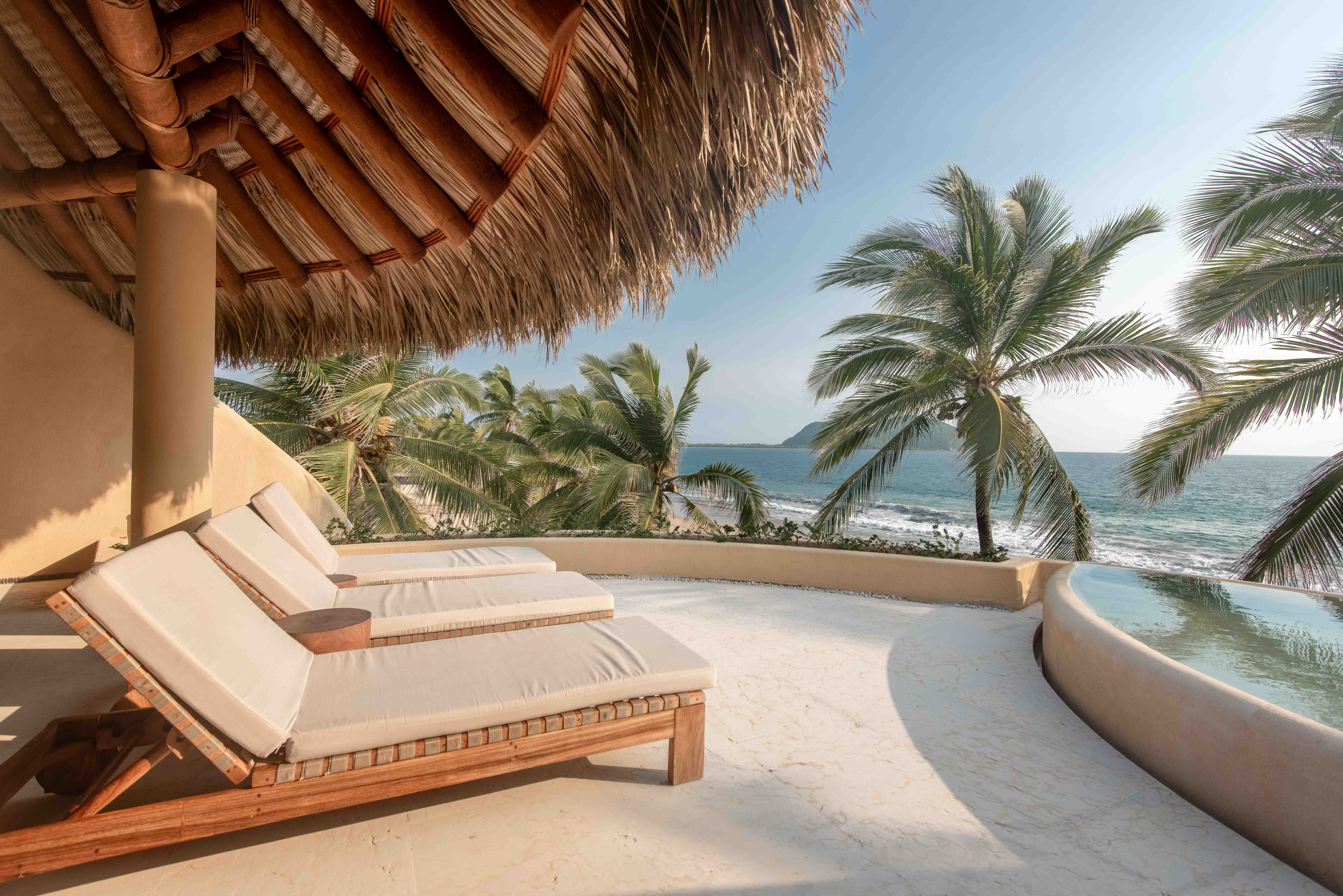 Penthouse terrace with jacuzzi, lounge chairs, palapa roof and Pacific Ocean view