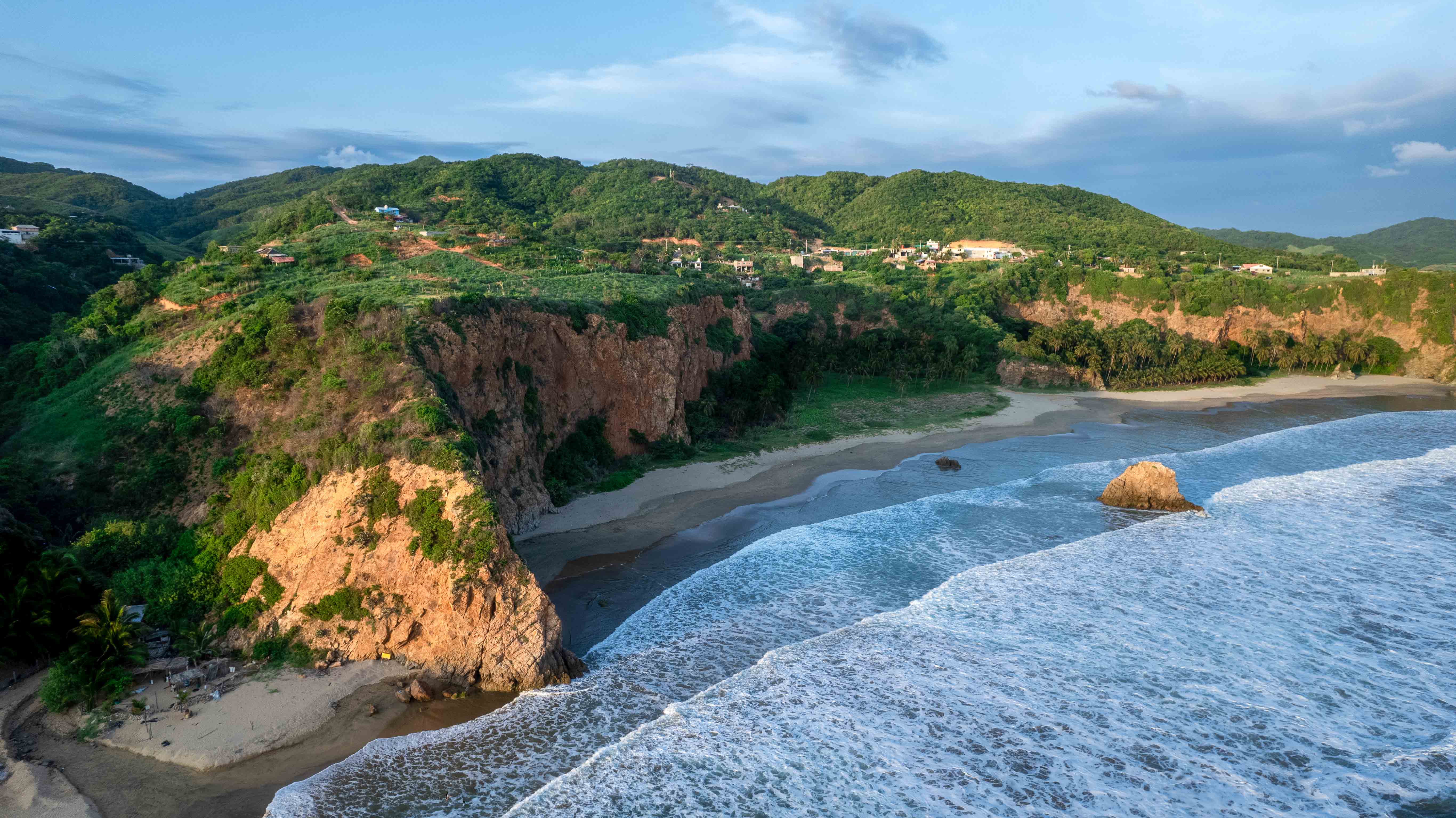 Aerial view of cliffs and Pacific Ocean at sunset in Caleta de Campos, Michoacán, Mexico