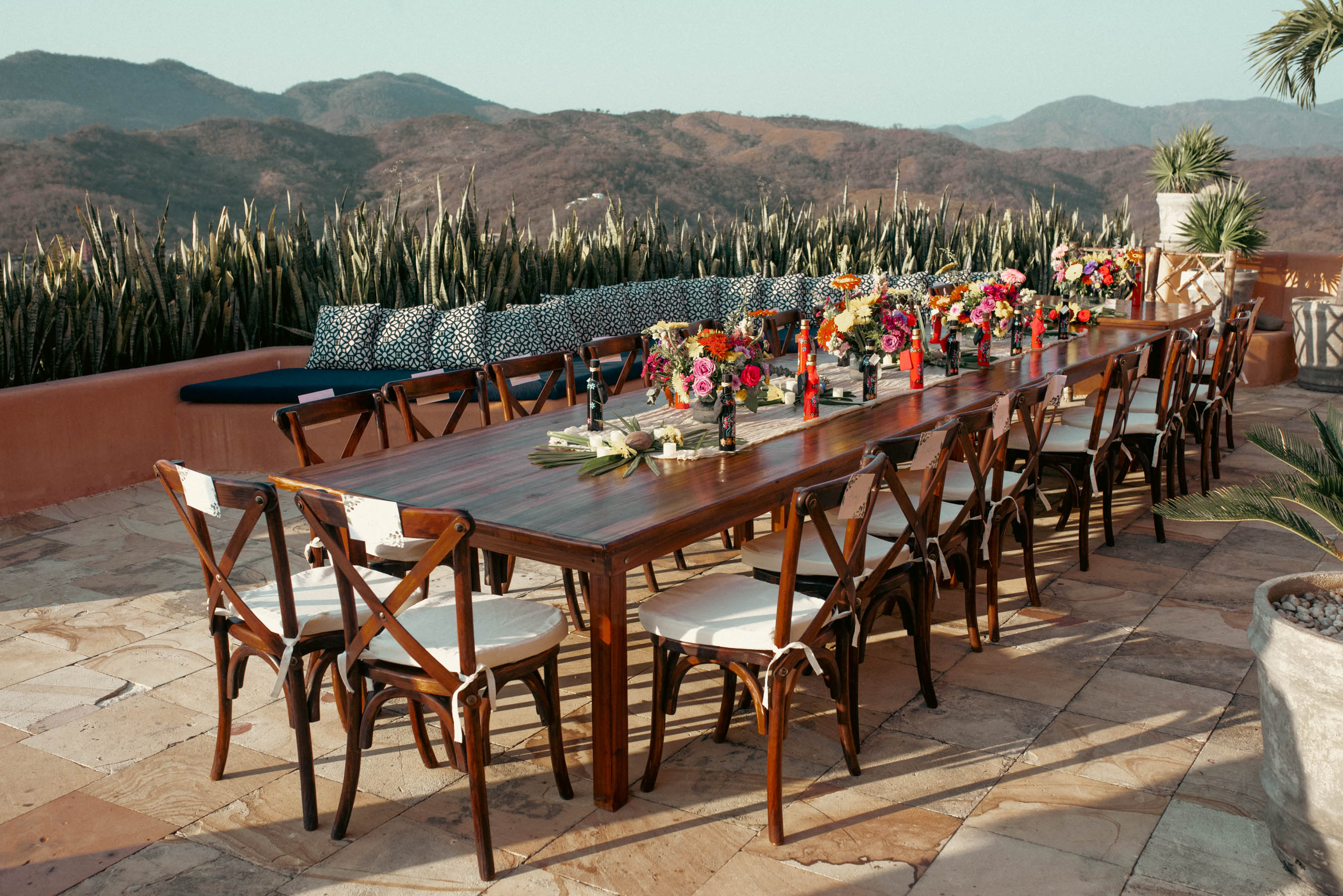Details of the beach-themed wedding reception, with tables adorned with seashell centerpieces and flickering candlelight