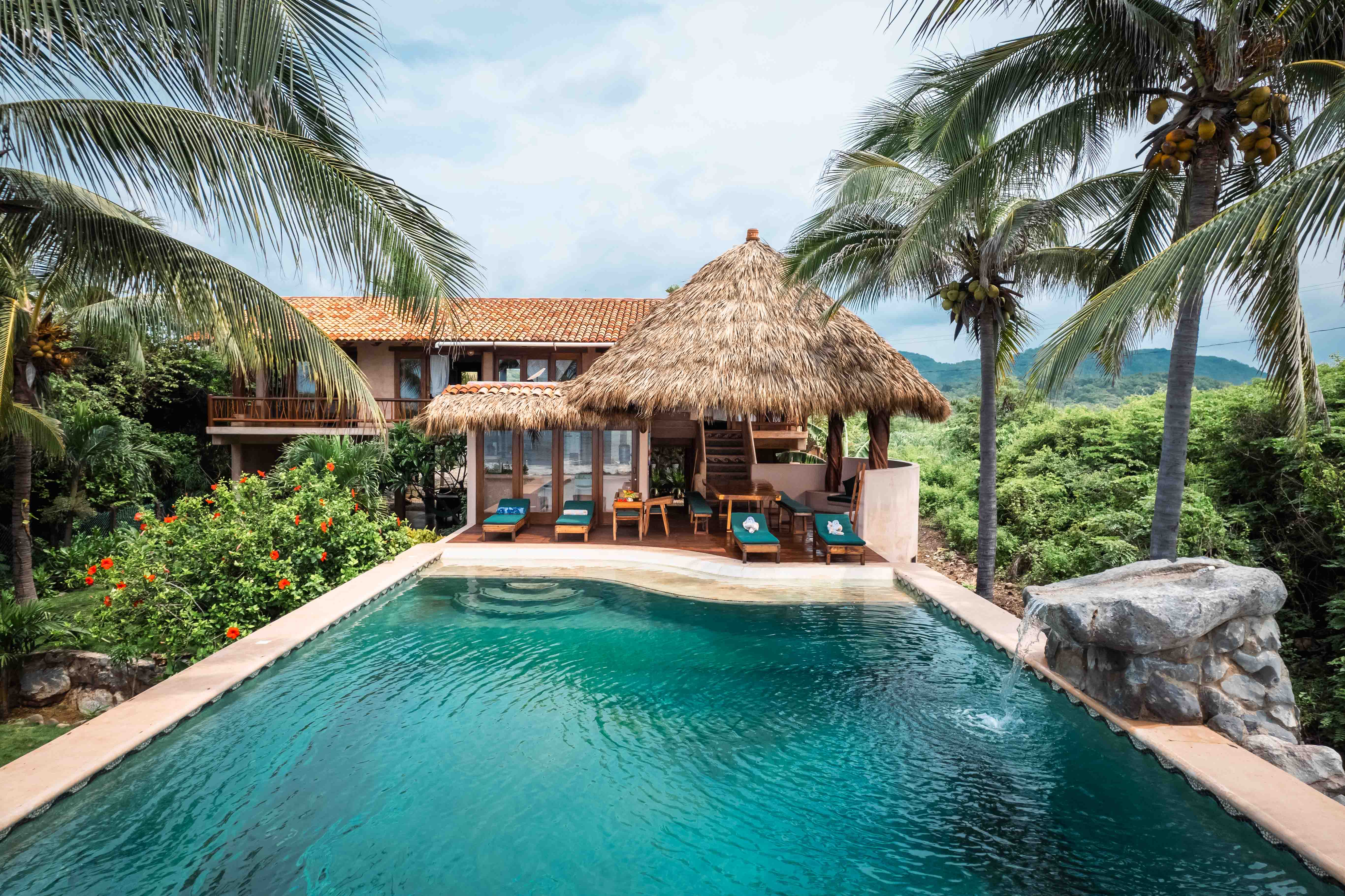 Tropical villa with swimming pool, palm trees, garden and mountain views in Mexico
