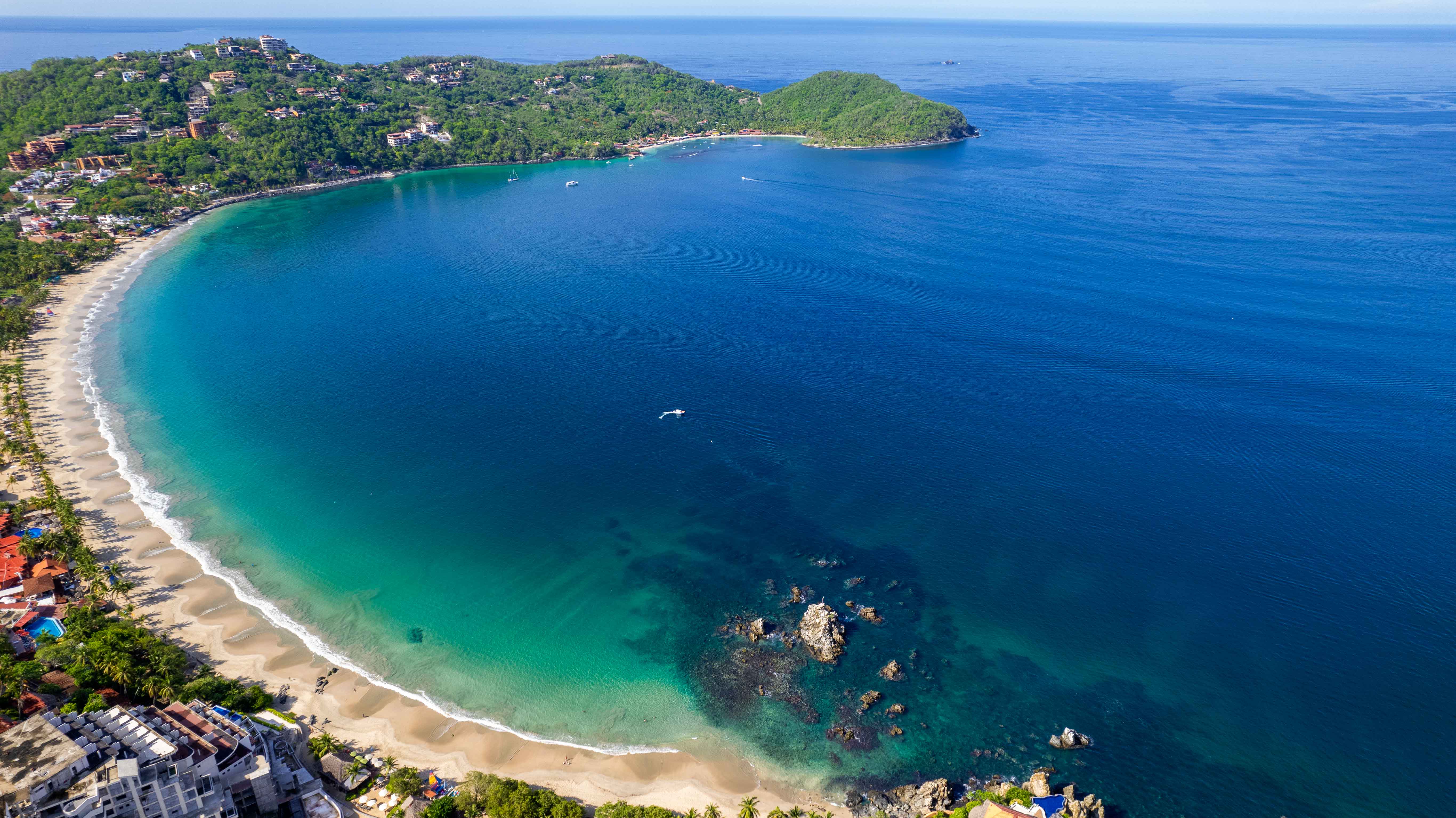 High-altitude aerial view of Playa La Ropa, Las Gatas and Zihuatanejo Bay in Mexico