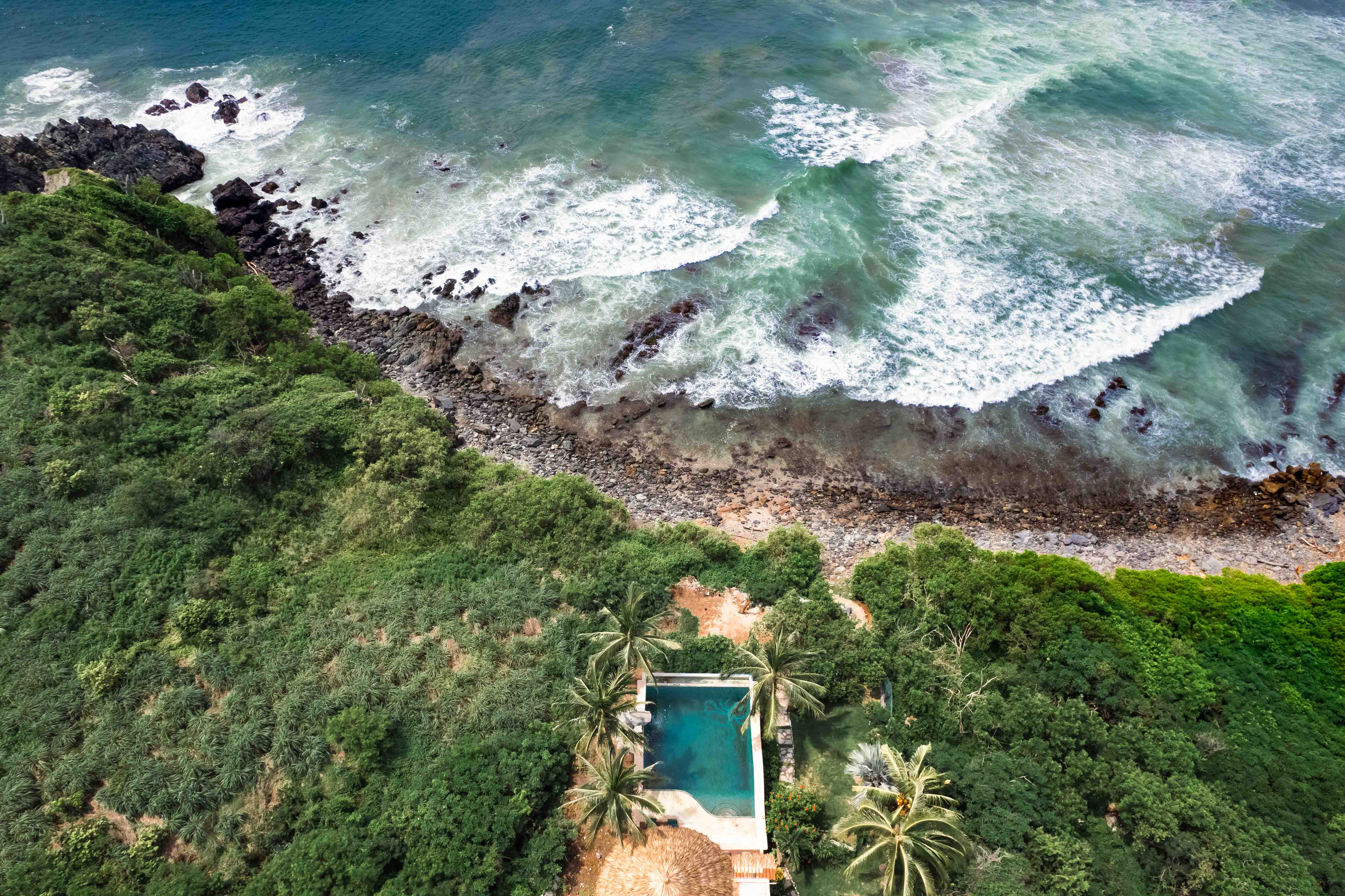 Isolated coastal property surrounded by tropical jungle and Pacific coastline in Mexico