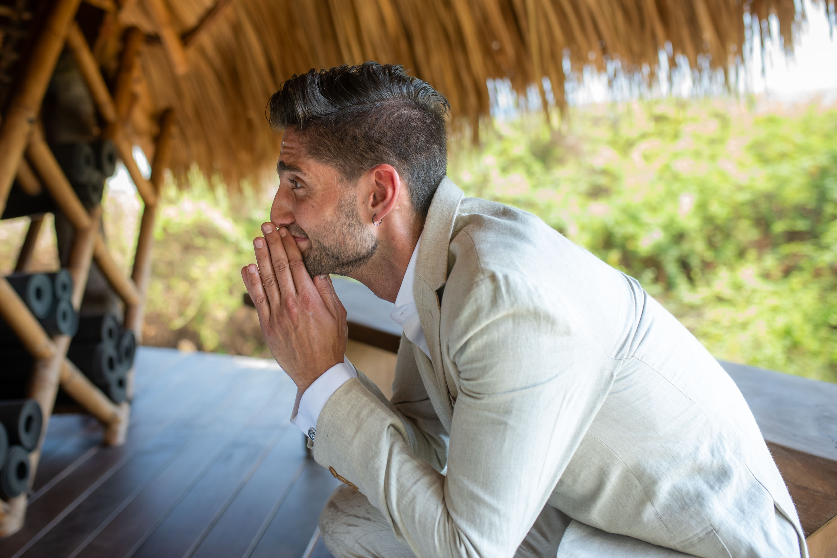 Groom waiting barefoot on the sand for a first look moment in Playa Viva, Mexico