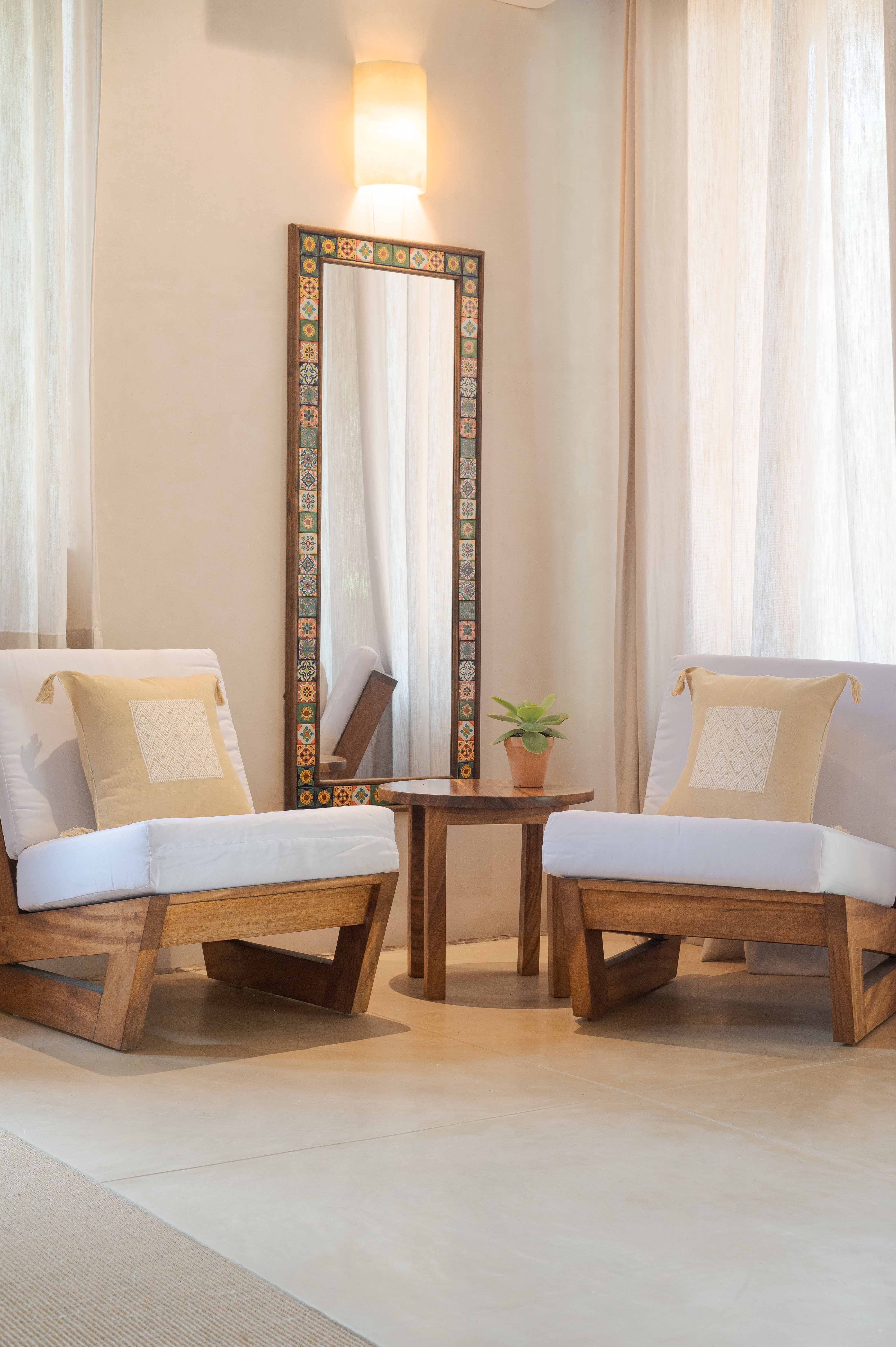 Designer bedroom with mirror, decorative lighting, curtains and chairs