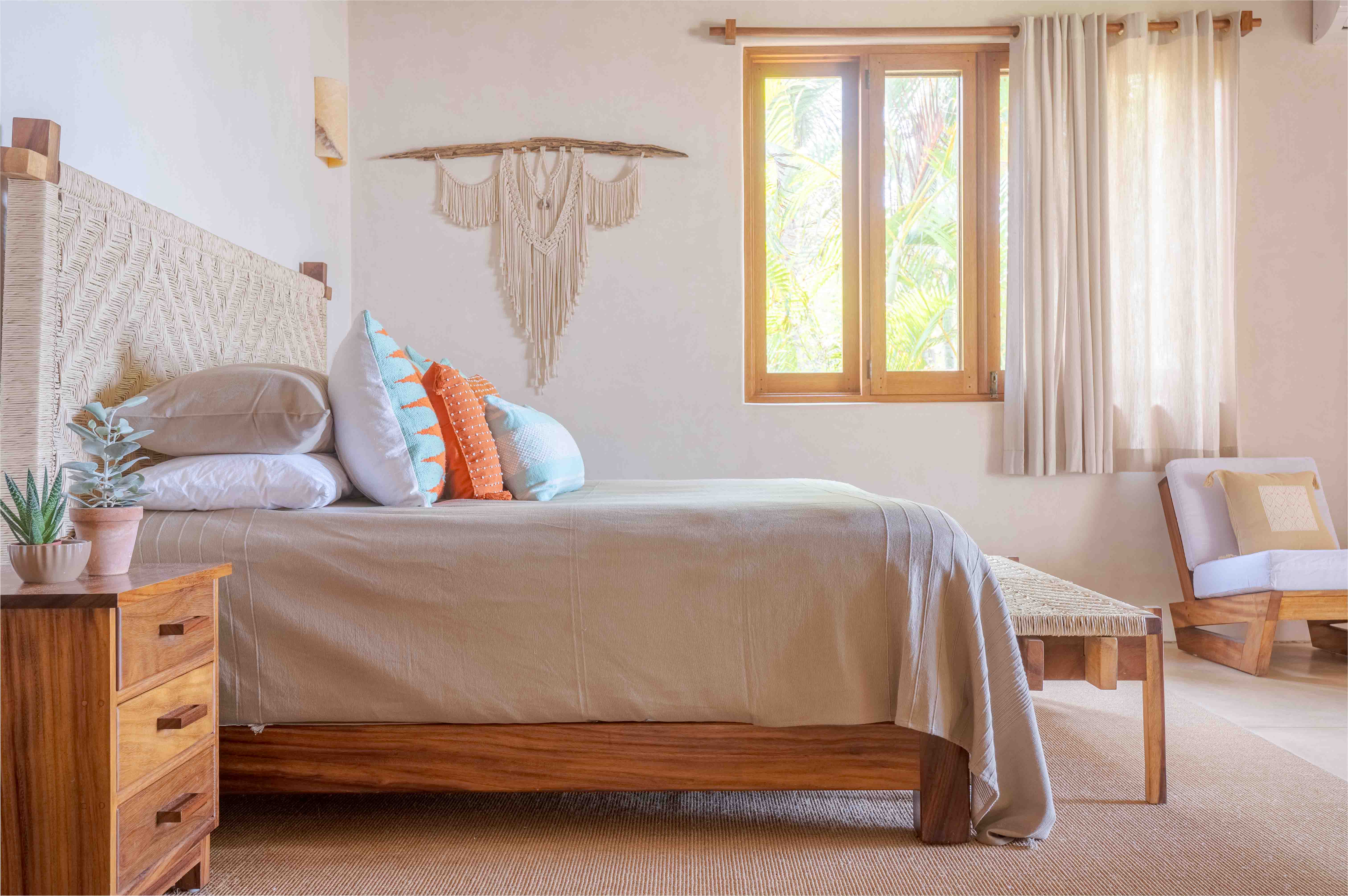 Designer bedroom with handmade textiles, pillows, curtains, carpet and curated furniture
