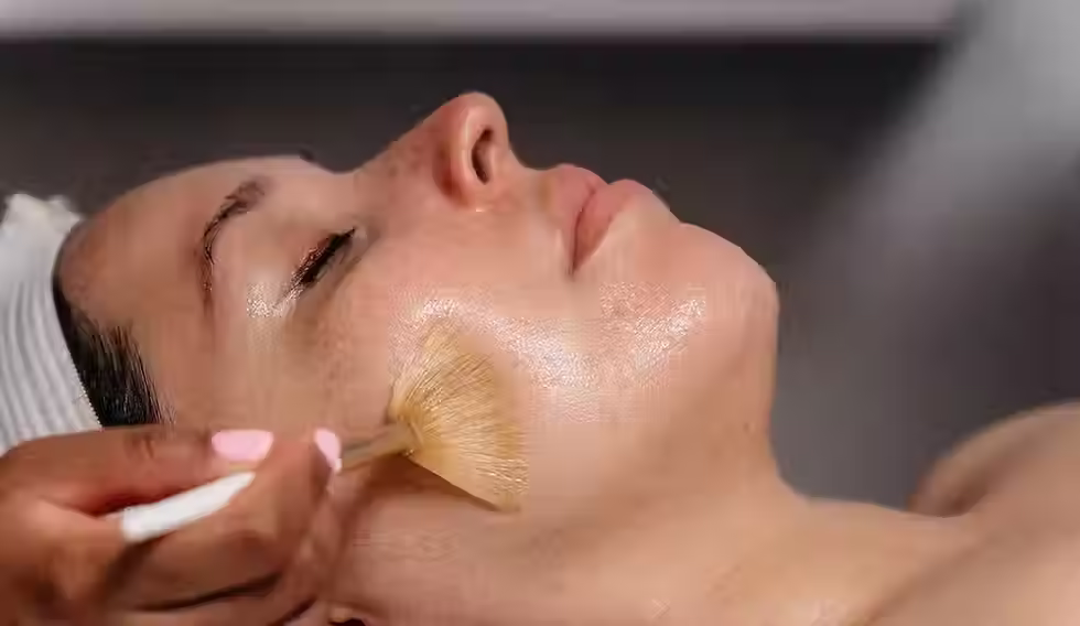Customer getting a Medi Peel with the brush applying the product to her cheek