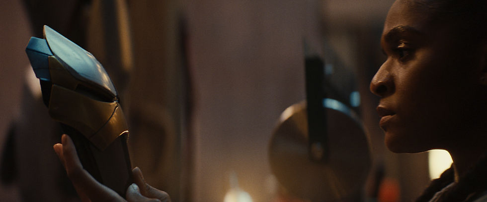 Riri Williams looking at her Ironheart mask.