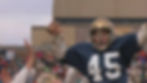 Sean Astin as Rudy getting carried off the field