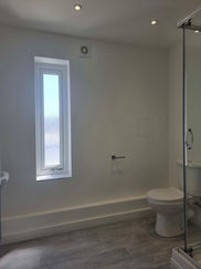Bathroom basin and heated towel rail beside window