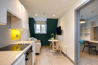 Studio apartment living area with fitted kitchen