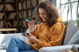 White Teen Waving on Zoom Call.jpg