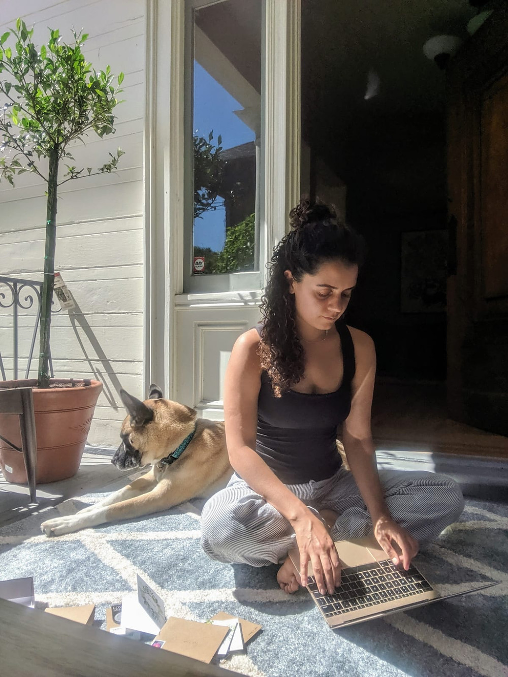a picture of me sitting outside on the porch on the computer