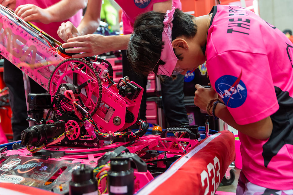 The Pink Team members working on a Pink FRC 233 robot.