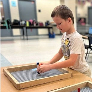A student working on a build plate at 3D-Printing & CAD Camp.