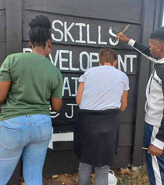 People working painting a wall