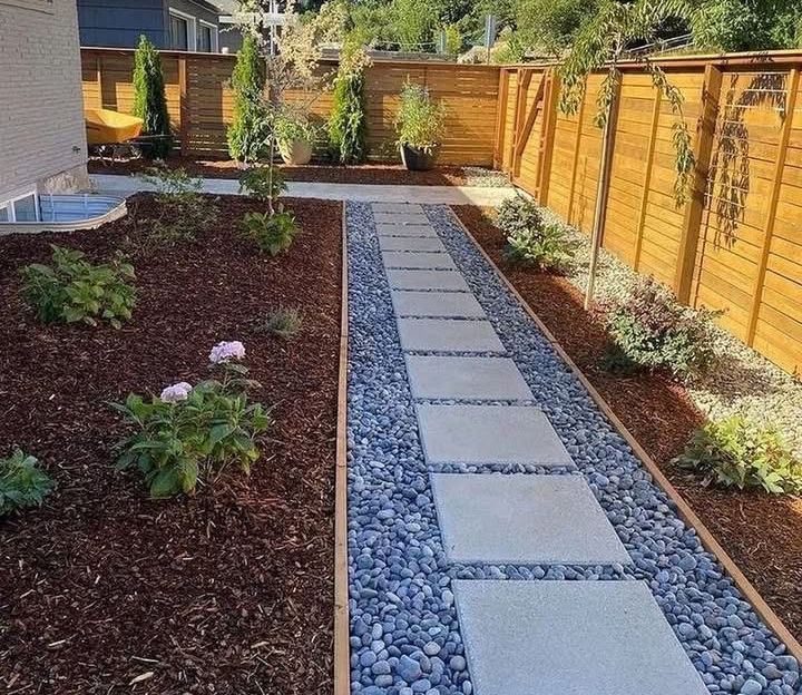 Modern side yard landscaping with stepping stone pathway and decorative gravel in Salt Lake City
