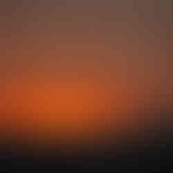 A vibrantly orange, red, and yellow sunset