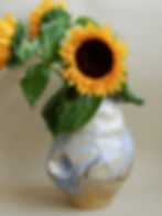 A hand-crafted piece with sunflower from "The Floral" collection, using delicate beige stoneware.