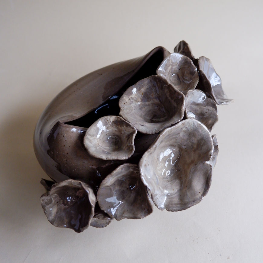 Embrace the beauty of "The Floral" collection with this hand-built piece, showcasing a graceful curve in dark brown stoneware