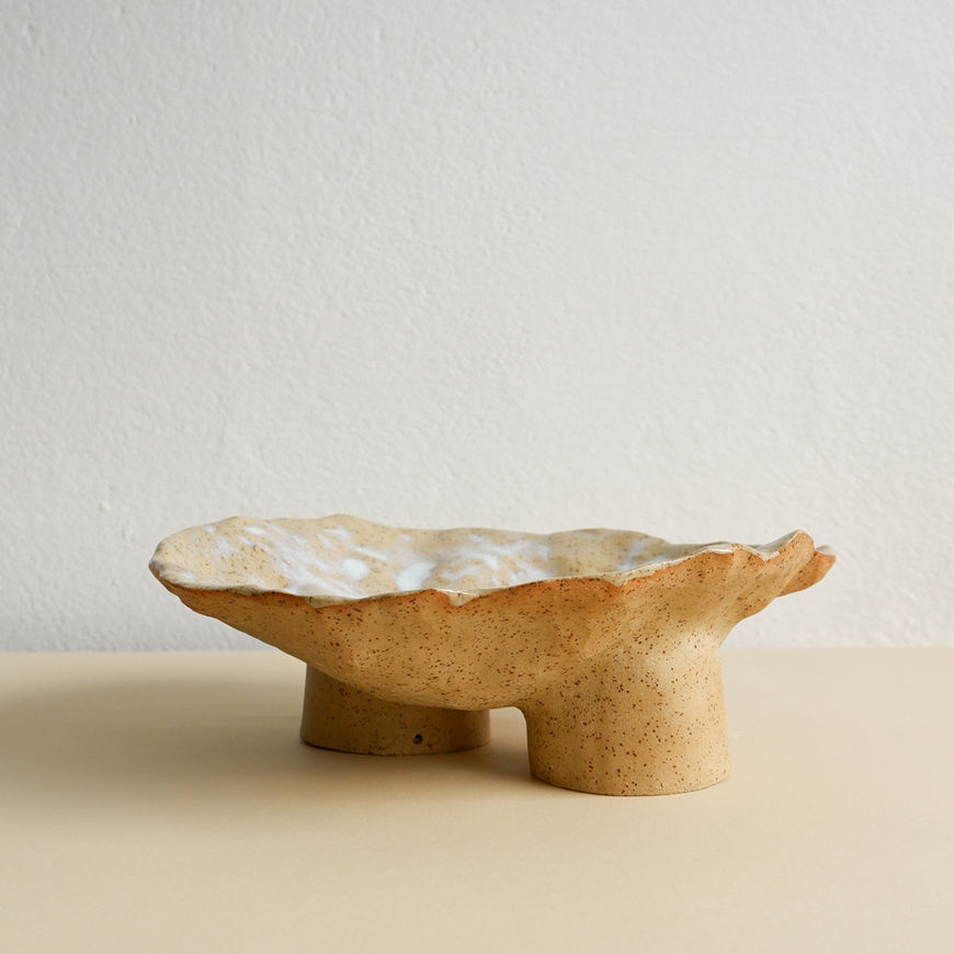 Handcrafted from olive-beige stoneware with dark speckles, this unique centerpiece combines natural beauty