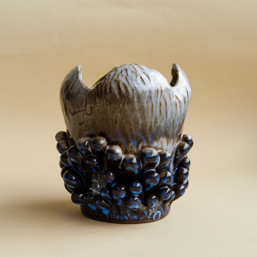 Richly decorated Vase with an interesting cut on the top edge