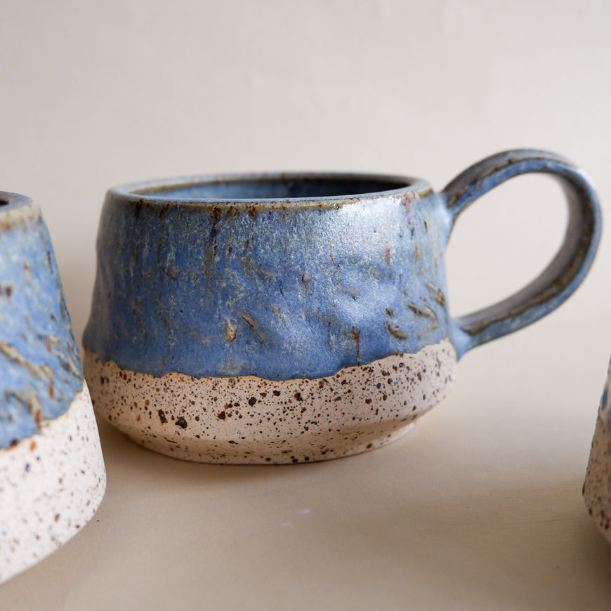 Blue speckled ceramic mug with handle