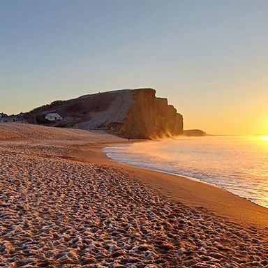 early morning on east beach in west bay with calm sea