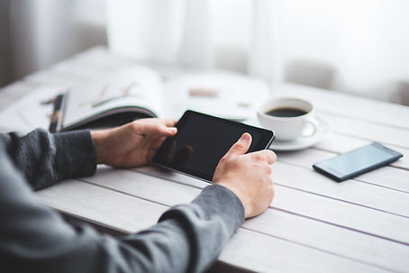 Guy with tablet and coffee