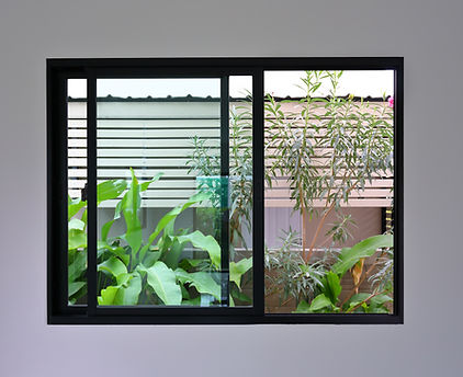 glass slide window replacement on white wall of a new house.jpg