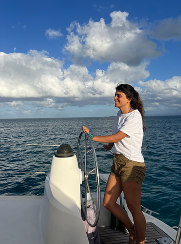 Captain steering a catamaran in San Blas, Panama