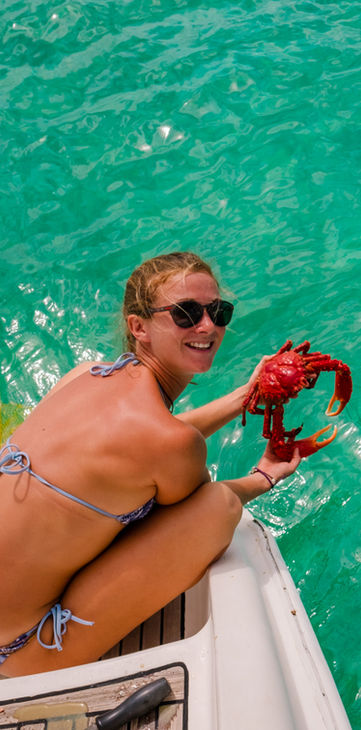Girl holding a freshly caught crab in San Blas, Panama