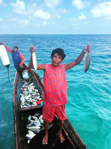 Local Guna fisherman offering fresh fish in San Blas, Panama