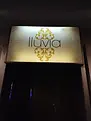 The Singapore gay bar has a sign that says "Luvia" in a dimly lit room, advertising the Lluvia