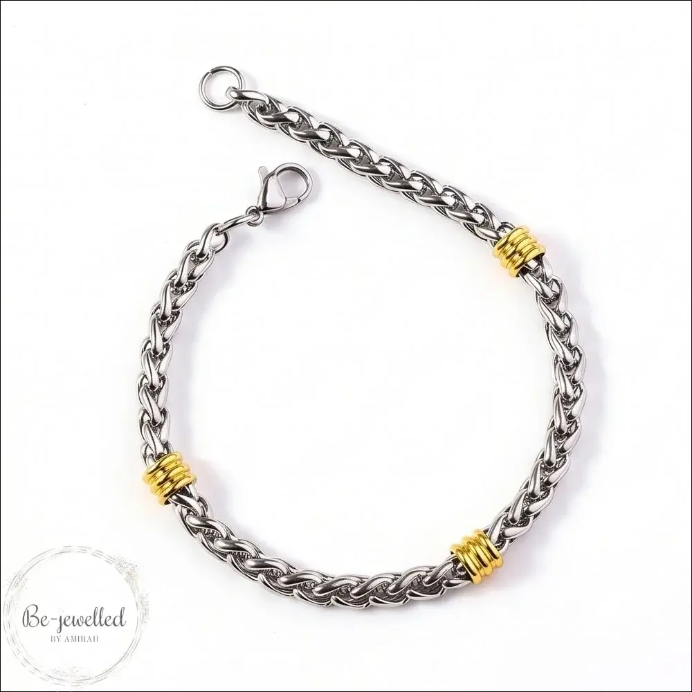 Men’s silver rope chain bracelet with gold accent rings on white background