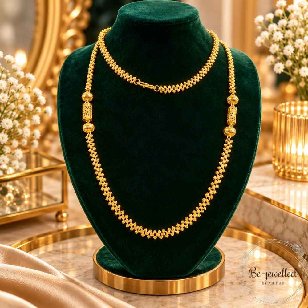Zariya Heritage Gold Beaded Long Necklace displayed on emerald green velvet with decorative cylindrical and spherical beads