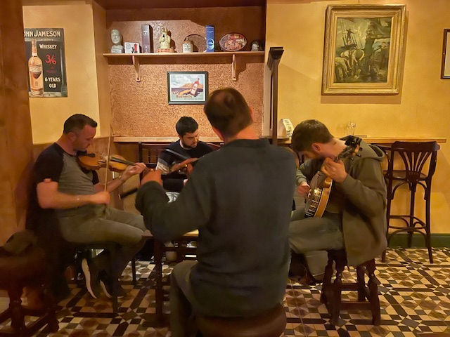 A flute, a violin, a guitar and a bouzouki.