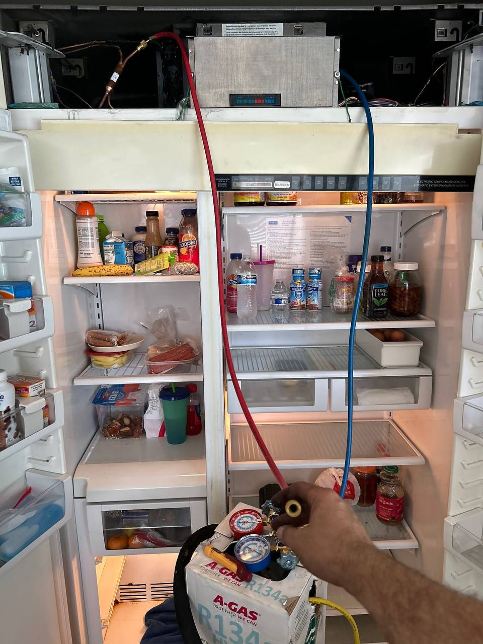 Technician performing premium appliance repair Los Angeles on a sub-zero fridge.