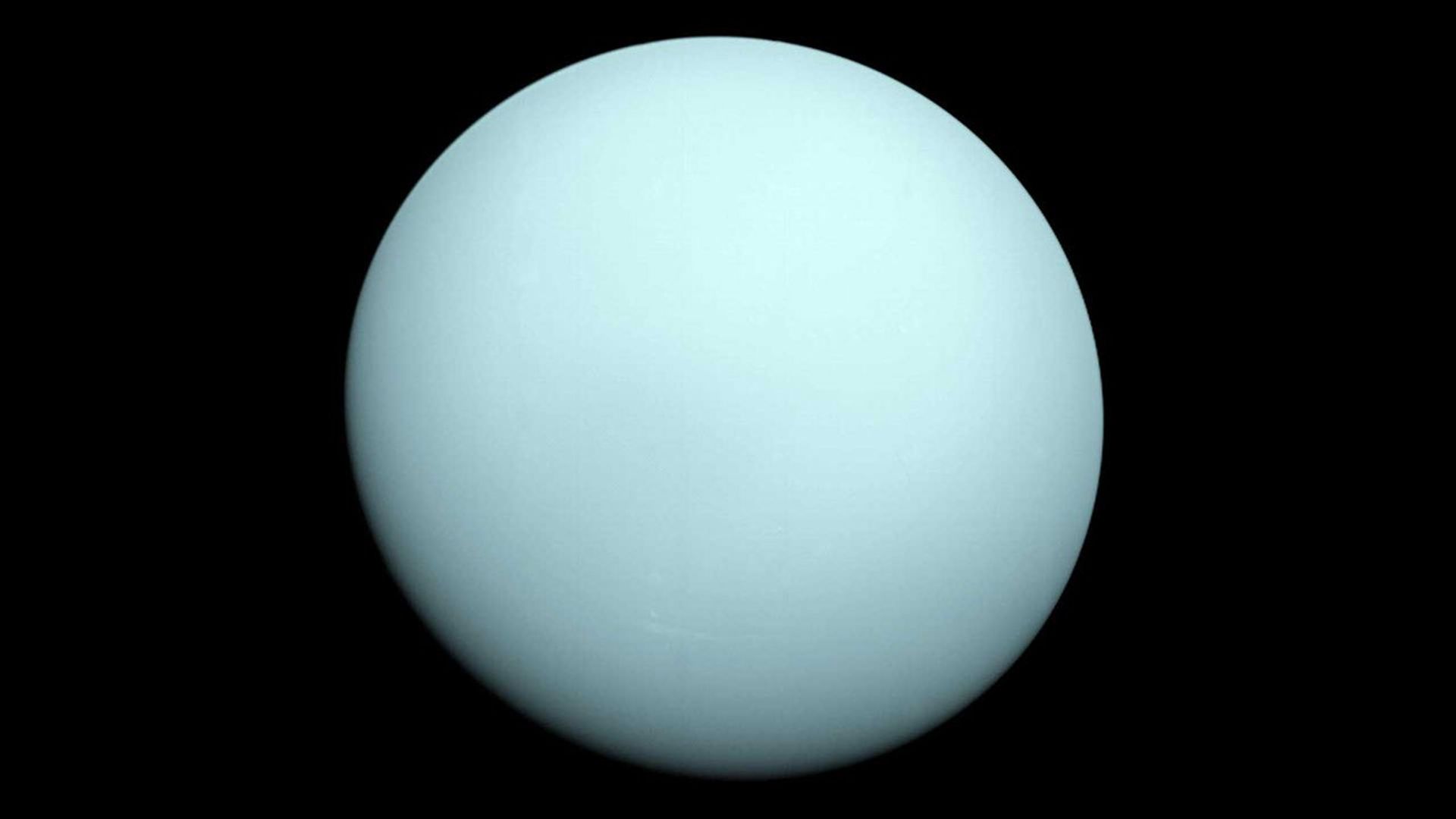 Voyager 2 image of Uranus in 1986, showing its pale blue-green globe.