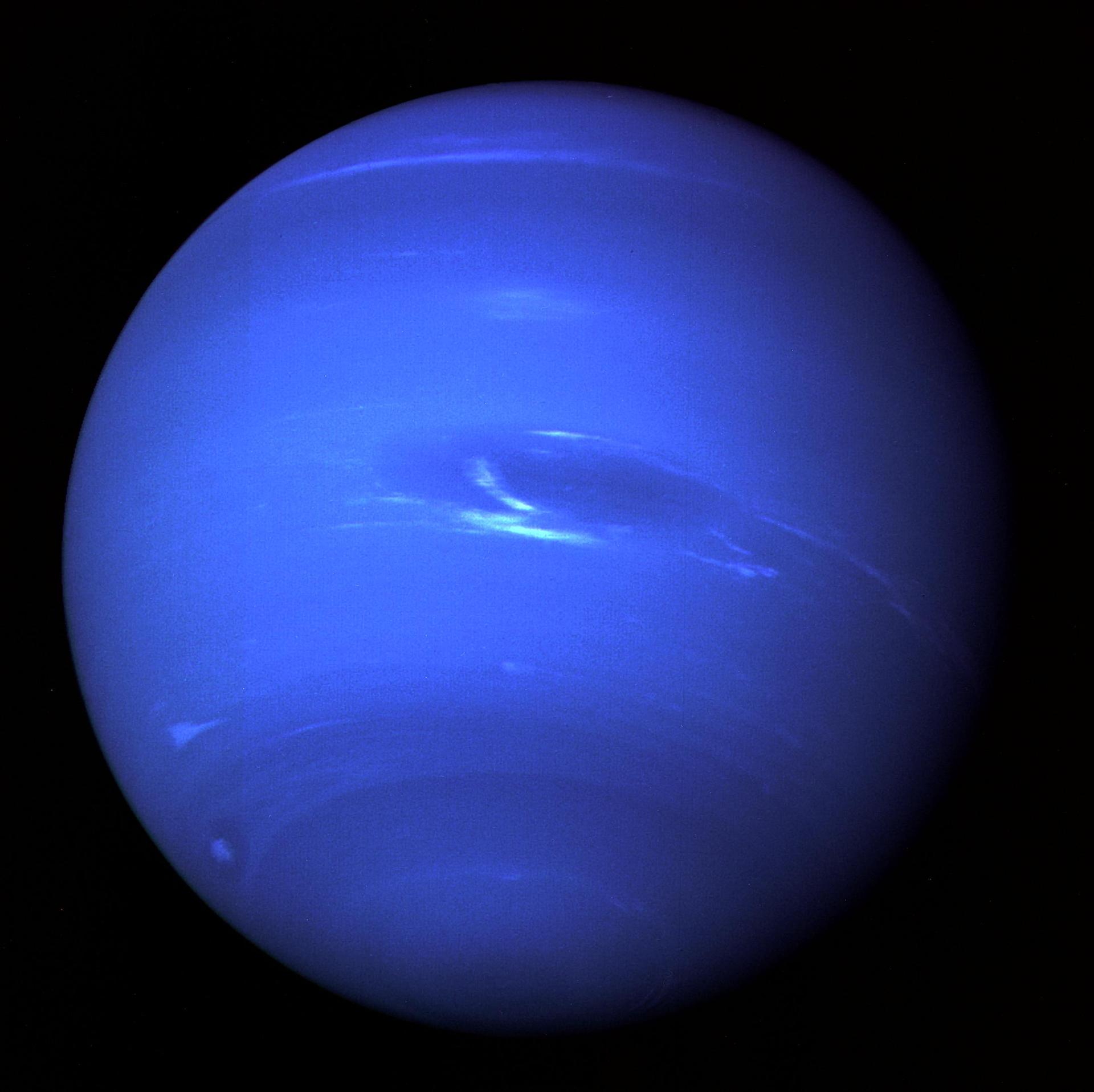 Voyager 2 full-disk view of Neptune showing the Great Dark Spot and bright clouds.