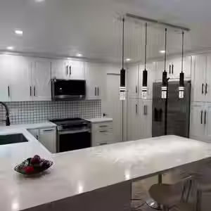 a kitchen with white cabinets and stainless steel appliances