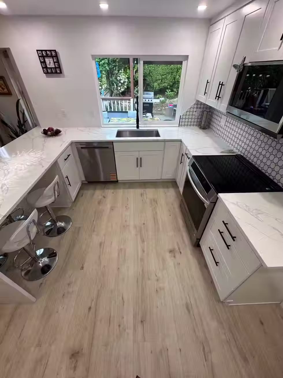 Custom kitchen in Bellevue with white cabinets and stainless steel appliances