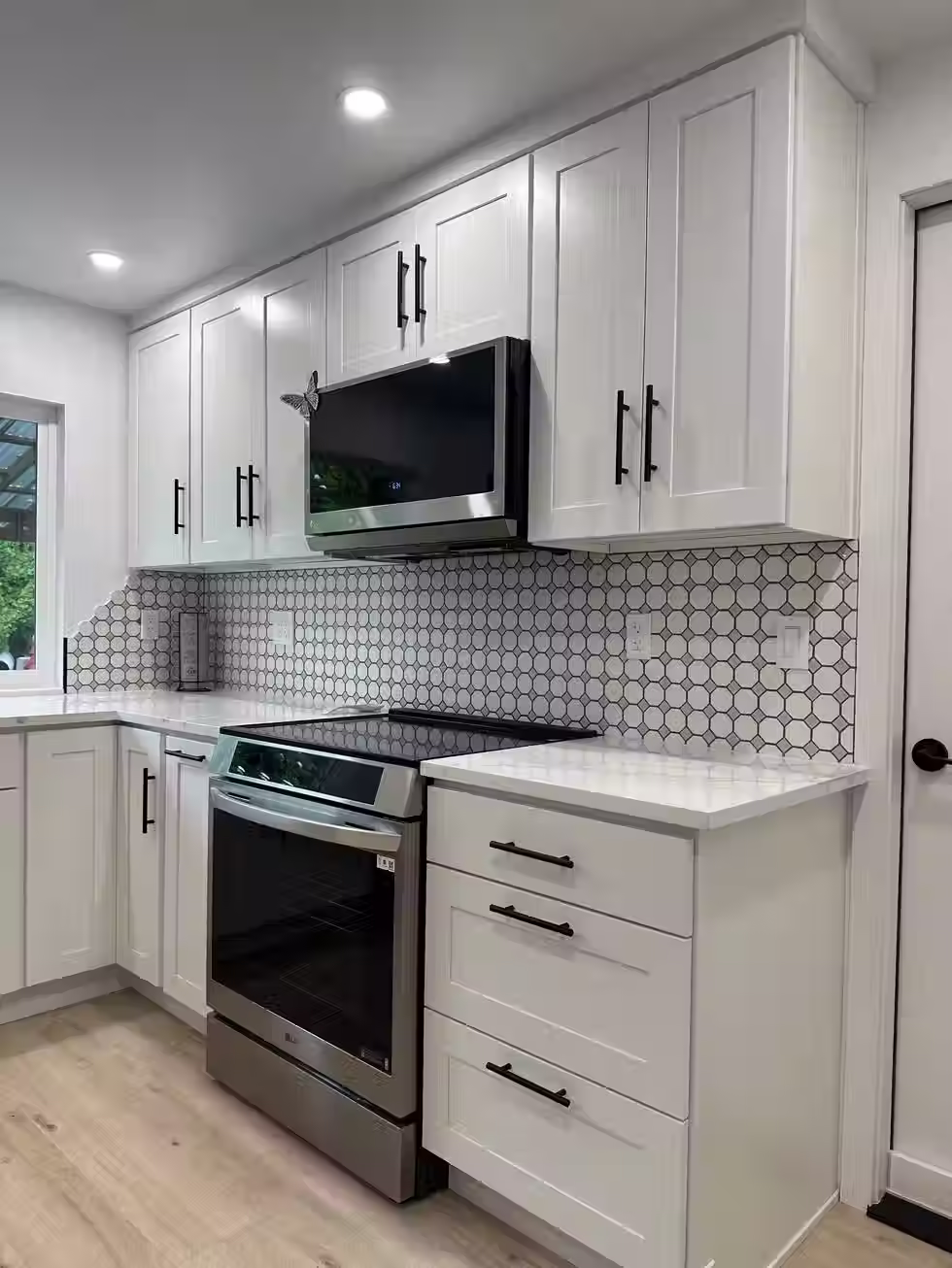 Custom kitchen in Bellevue a kitchen with stainless steel appliances and white cabinets
