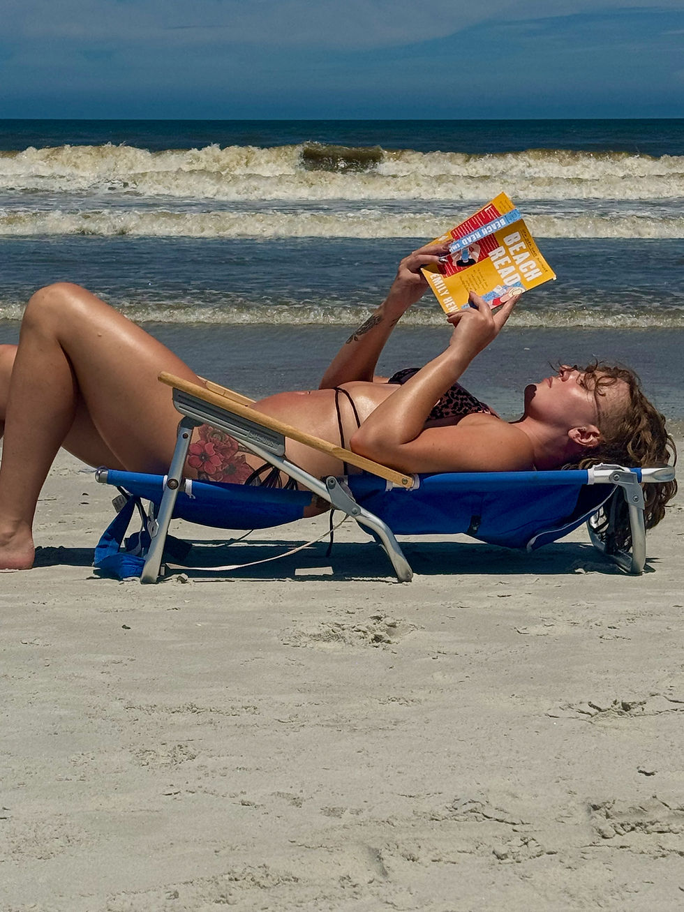Reading Beach Read by Emily Henry on Neptune Beach.