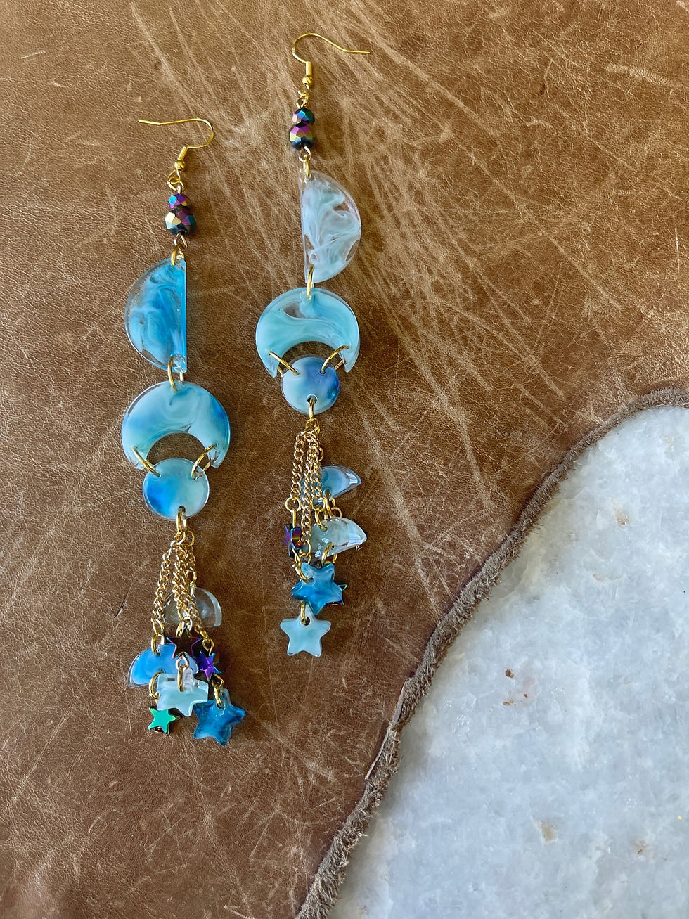 Thumbnail: Handcrafted resin earrings in blues and white swirls in clear resin!