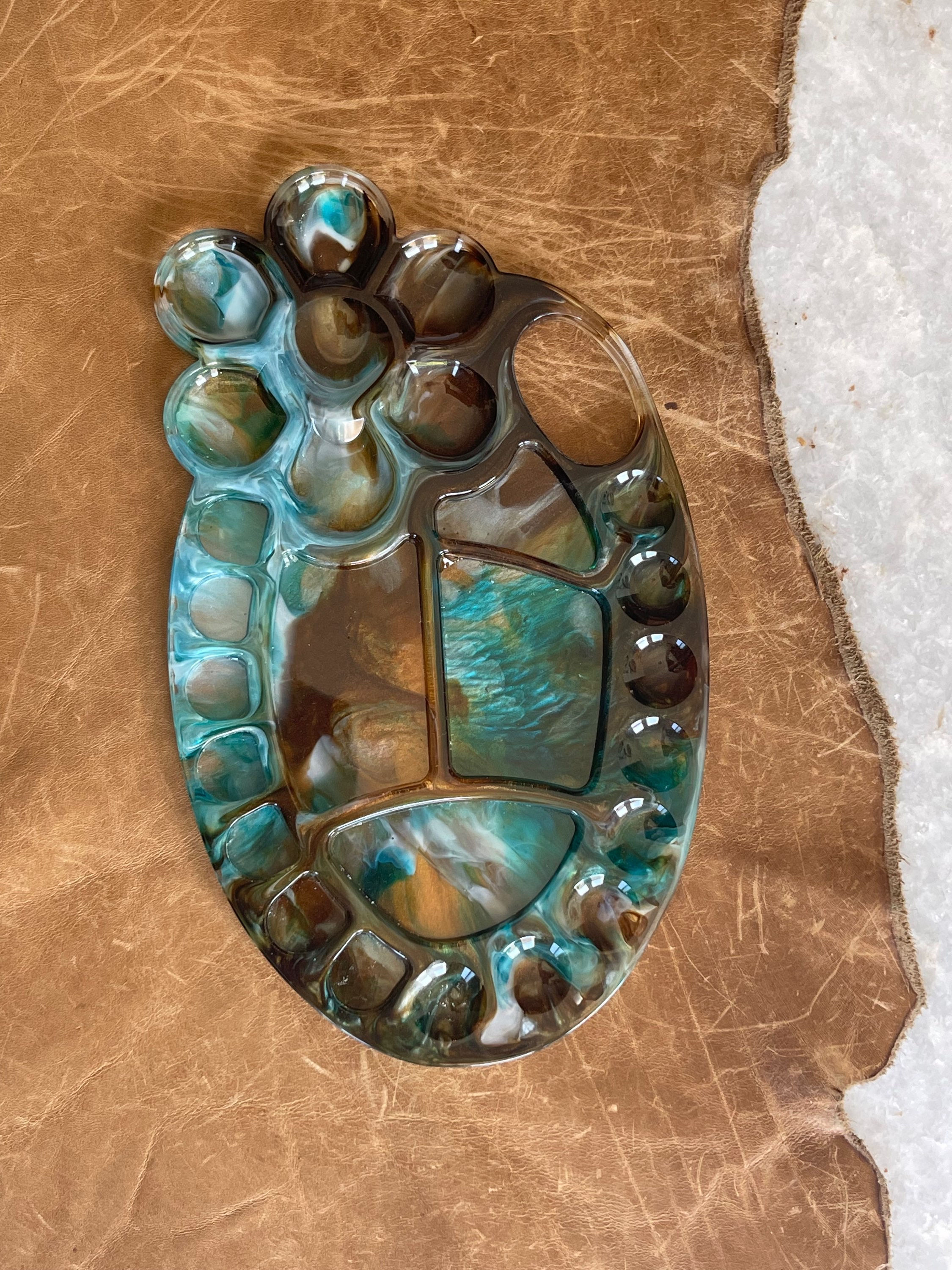 Floral shaped painters pallet in blues, white and browns 