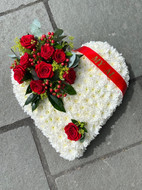 White based heart with a red corsage
